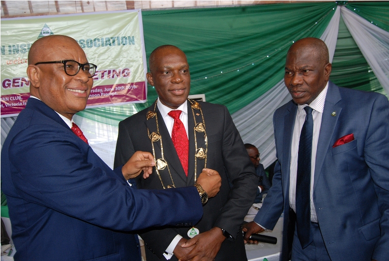 L-R: Immediate past chairman, Nigerian Insurance Association (NIA), Godwin Wiggle, decorating the Managing Director, Consolidated Hallmark Insurance Plc, Mr Eddie Efekoha, as new NIA Chairman, with Director General, NIA, Sunday Thomas, during the 45th Annual General Meeting of NIA held in Lagos on Thursday 30:6:2016.